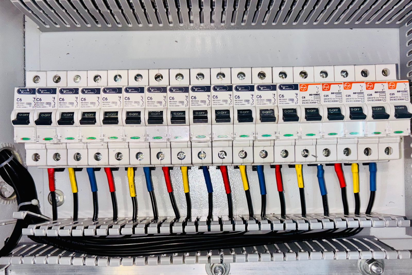 A residential breaker panel with the deadfront removed, showing the branch breakers.