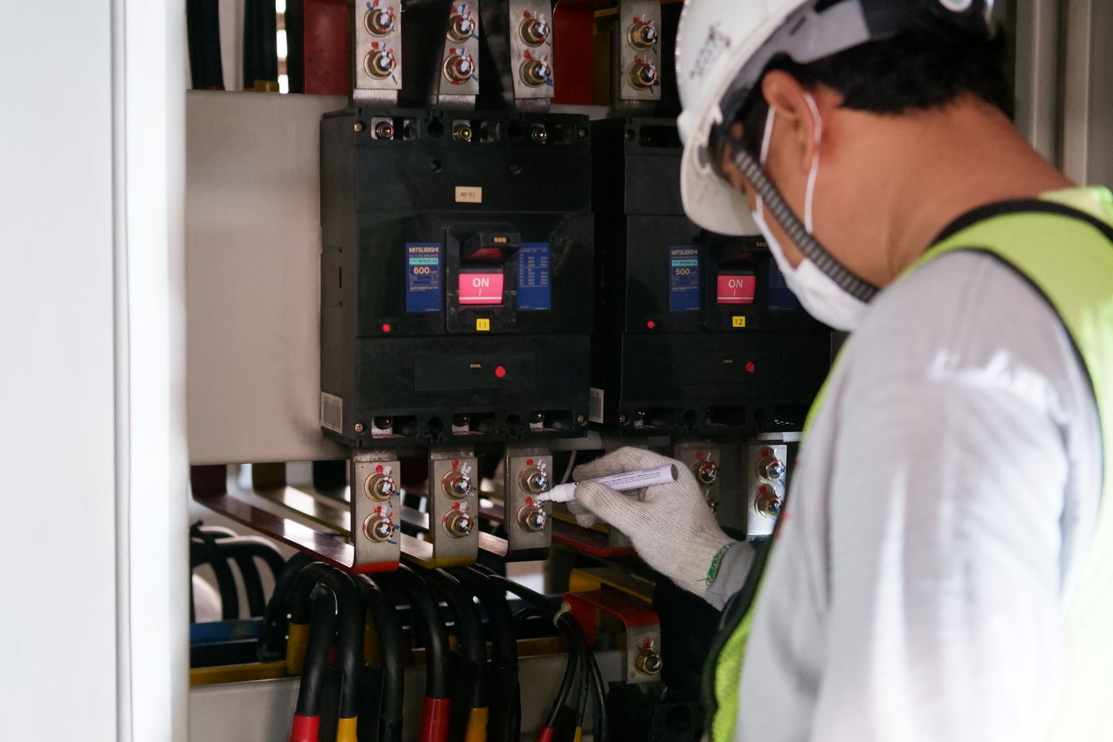 A technician working on a commercial electrical control panel.