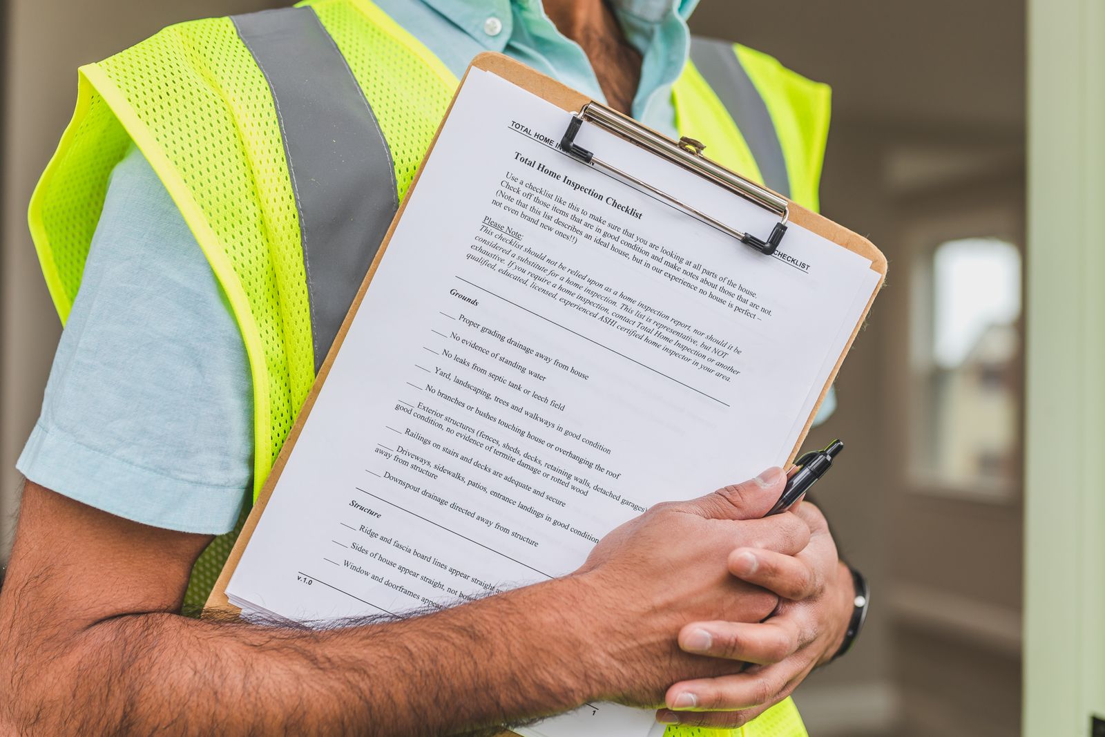 An inspection being recorded on a clipboard during an electrical safety check.