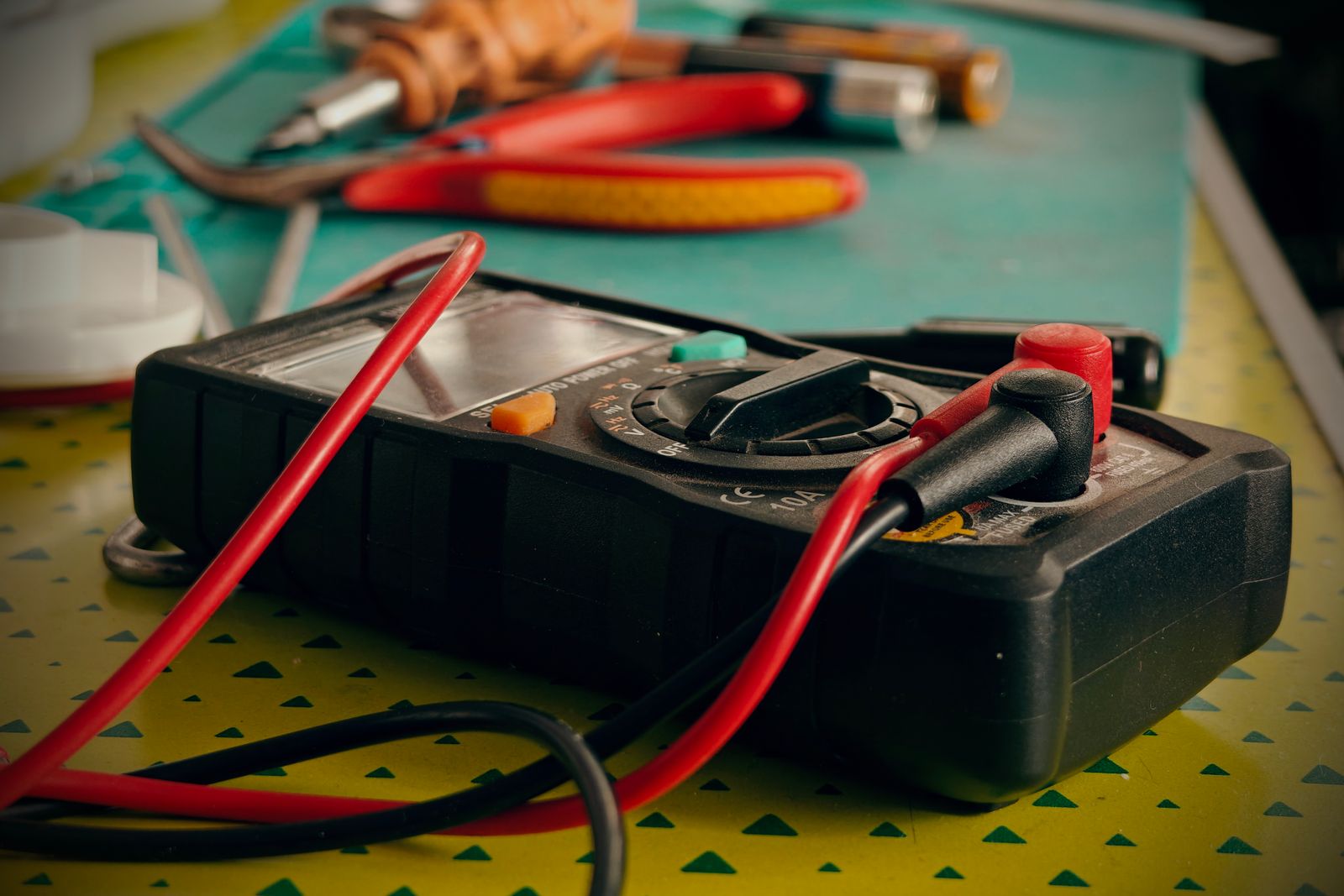 Electrical hand tools, strippers and pliers laid out on a work surface.
